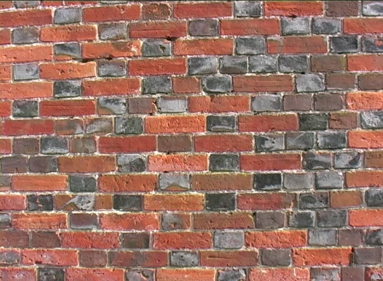 Wikipedia Description of what a brick is . This picture shows Brickwork using a 'Flemish' bond  with glazed headers and 18th century 'orangy red' handmade brick. EspadaRolls!